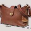 Brown textured leather handbag with a gold turn-lock, short top handle, and shoulder strap; dimension labels show height 16 cm, width 26 cm, and depth 6.5 cm.